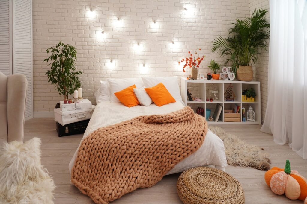 bed-with-light-bed-linen-covered-with-knitted-blanket-coarse-yarn